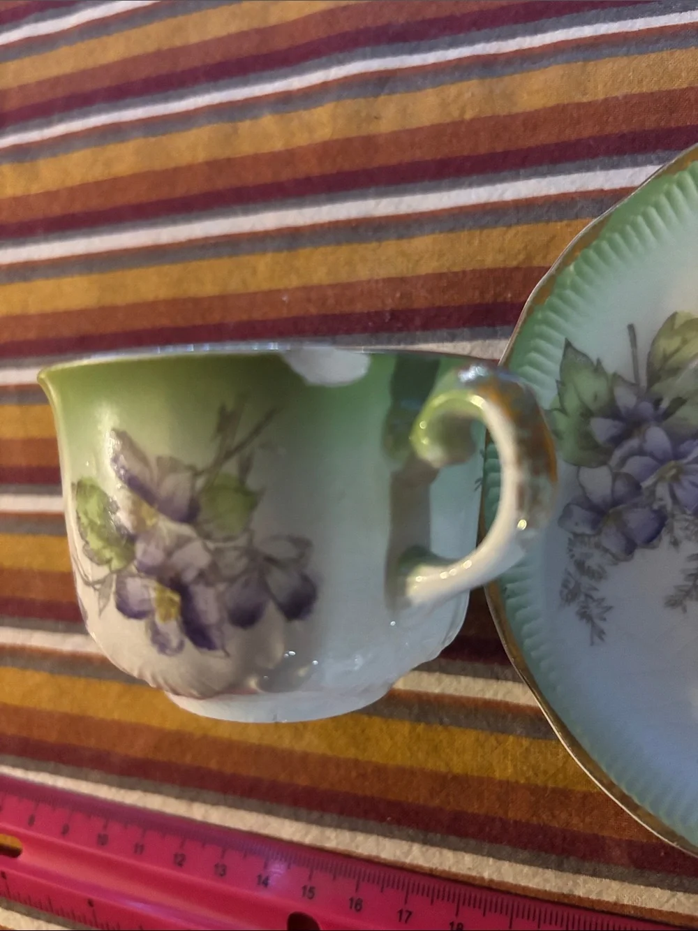 Green Porcelain Teacup and Saucer with Purple Floral Accents